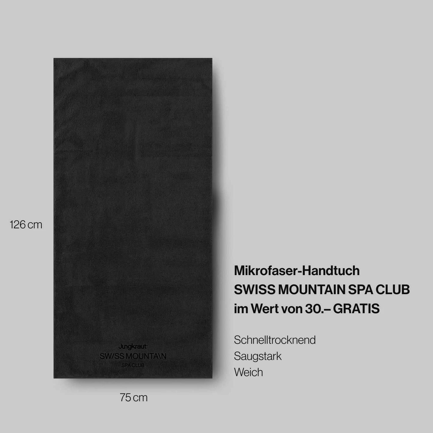 Schwarzes Mikrofaser-Handtuch mit der Aufschrift Jungkraut SWISS MOUNTAIN SPA CLUB liegt flach auf grauem Hintergrund. Daneben sind die Maße 126 cm x 75 cm angegeben. Rechts steht der Text: Mikrofaser-Handtuch SWISS MOUNTAIN SPA CLUB im Wert von 30.– GRATIS – Schnell trocknend, saugstark, weich. Das Bild betont Qualität und Funktionalität des Handtuchs.